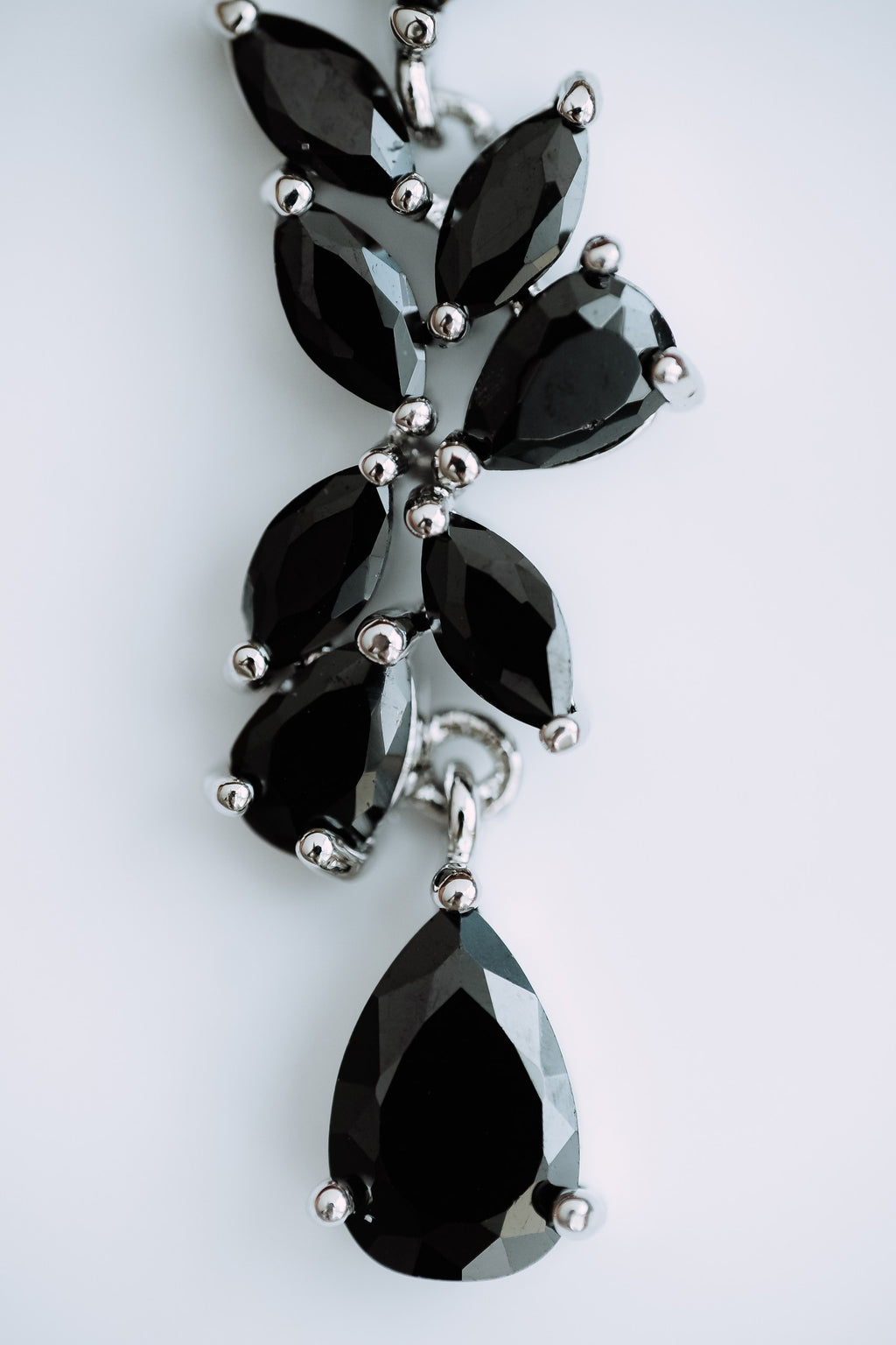 Cubic zirconia vine marquise drop earrings black silver - worn styling shot showing scale
